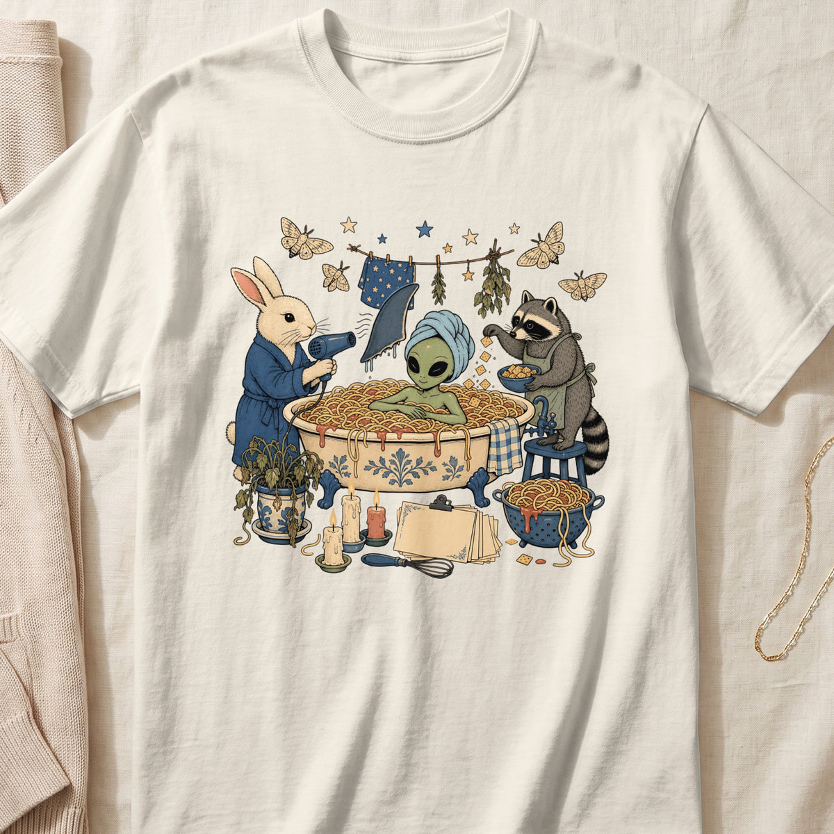 Off-white crewneck t-shirt featuring a vintage-style graphic of an alien bathing in spaghetti, assisted by a rabbit and a raccoon.