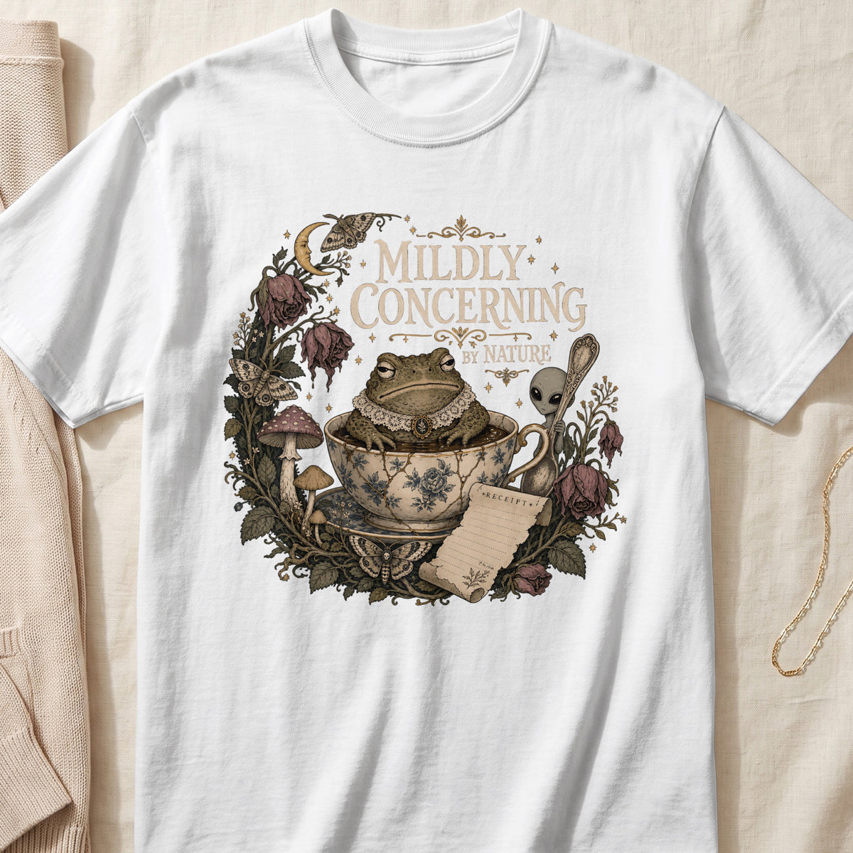 Frog in teacup with "Mildly Concerning By Nature" text, surrounded by moths and roses.