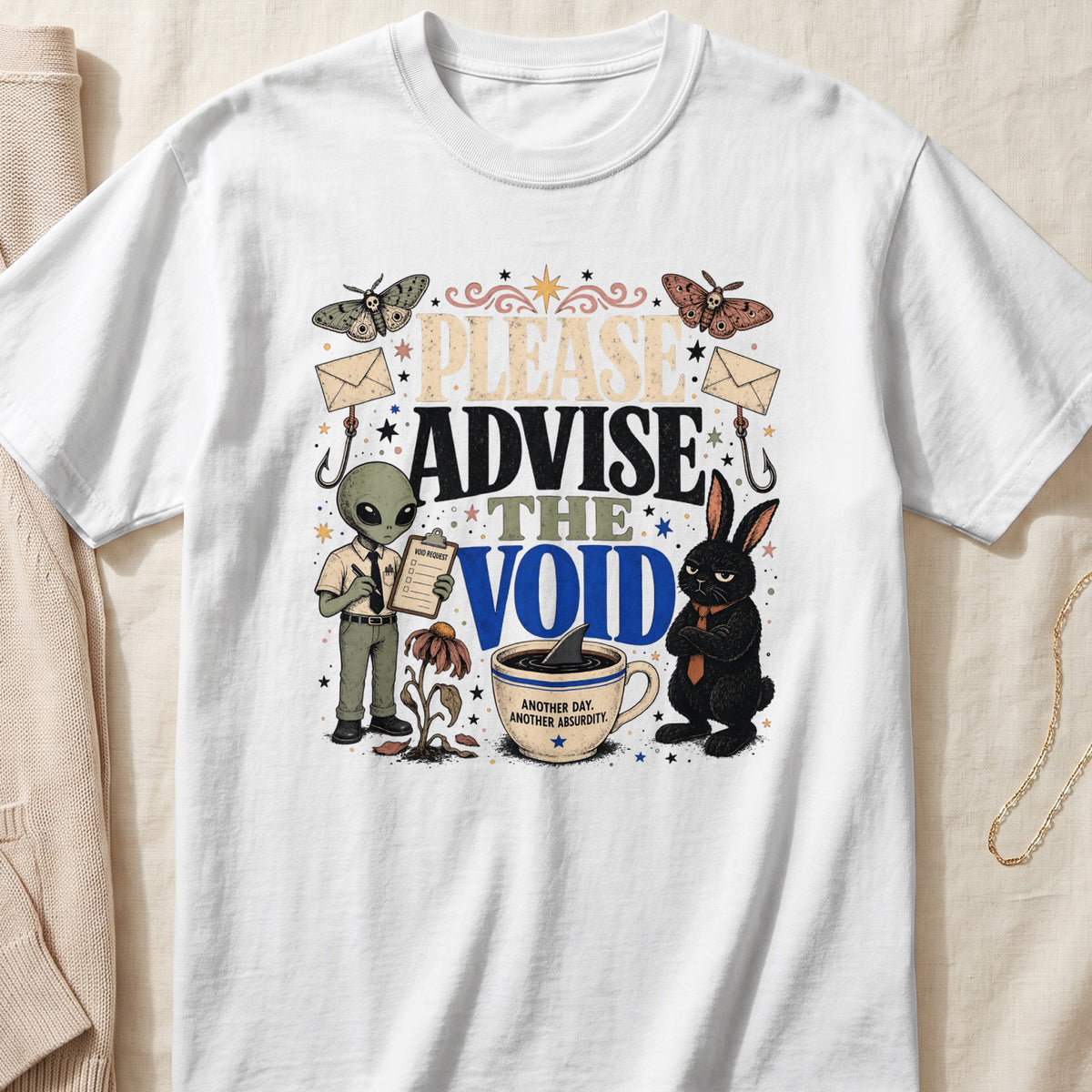 Alien, rabbit, moths, and text "Please Advise The Void" on a white t-shirt.