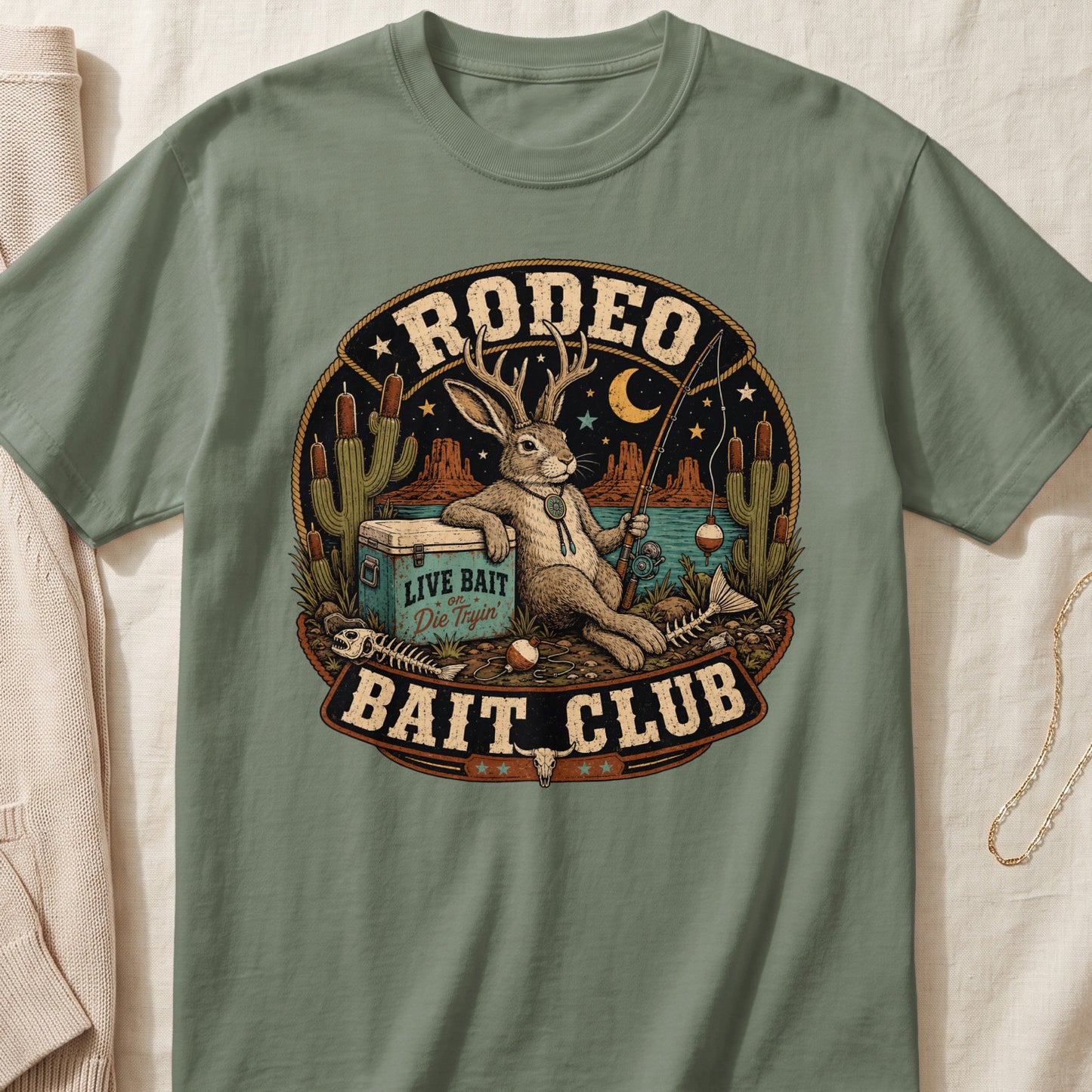 Rabbit with antlers fishing, "RODEO BAIT CLUB LIVE BAIT Die Tryin" text.