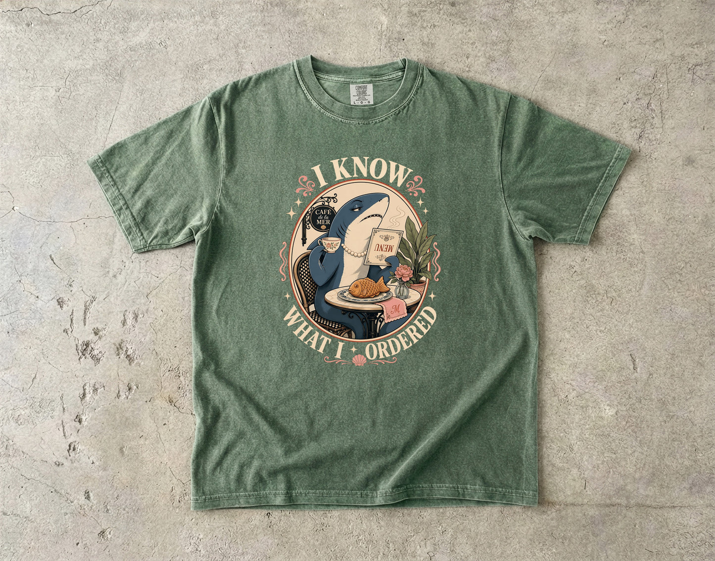 Green t-shirt with a shark reading a menu and text "I KNOW WHAT I ORDERED."