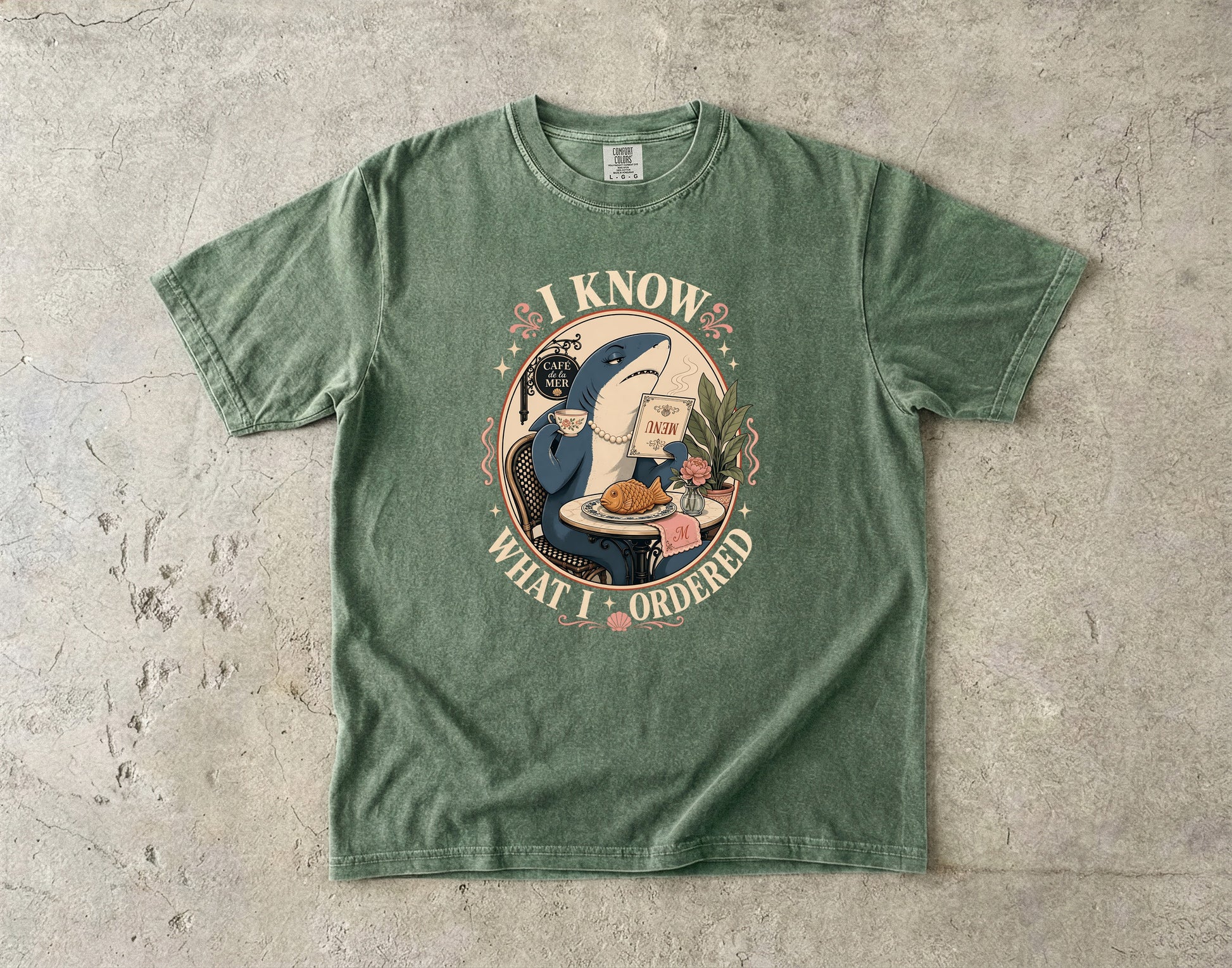 Green t-shirt with a shark reading a menu and text "I KNOW WHAT I ORDERED."