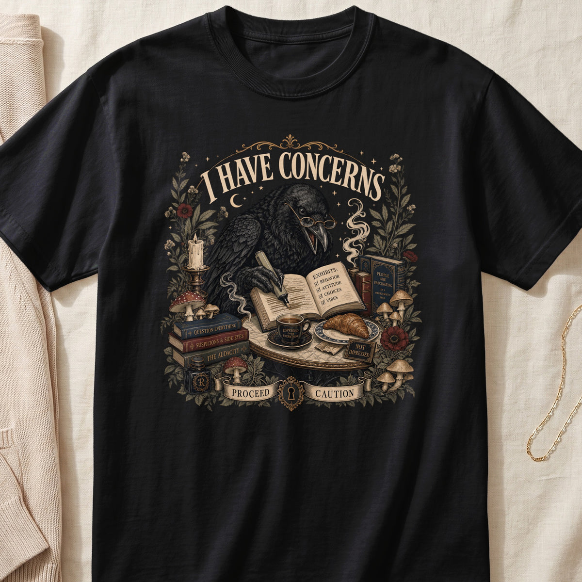 Black t-shirt with a raven wearing glasses, writing in a book with "I HAVE CONCERNS" text.