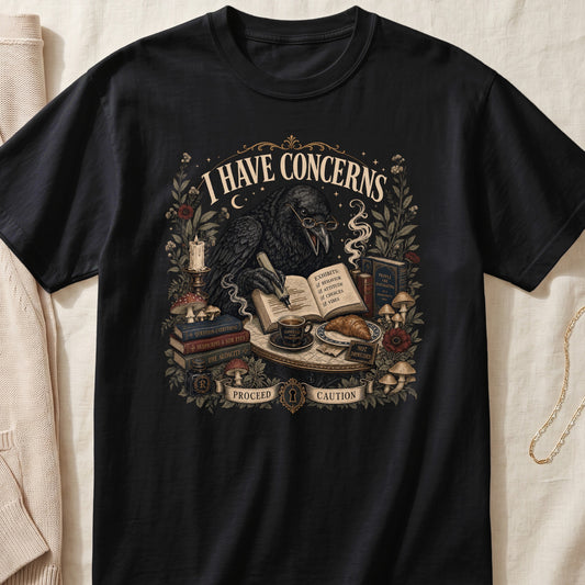 Black t-shirt with a raven wearing glasses, writing in a book with "I HAVE CONCERNS" text.