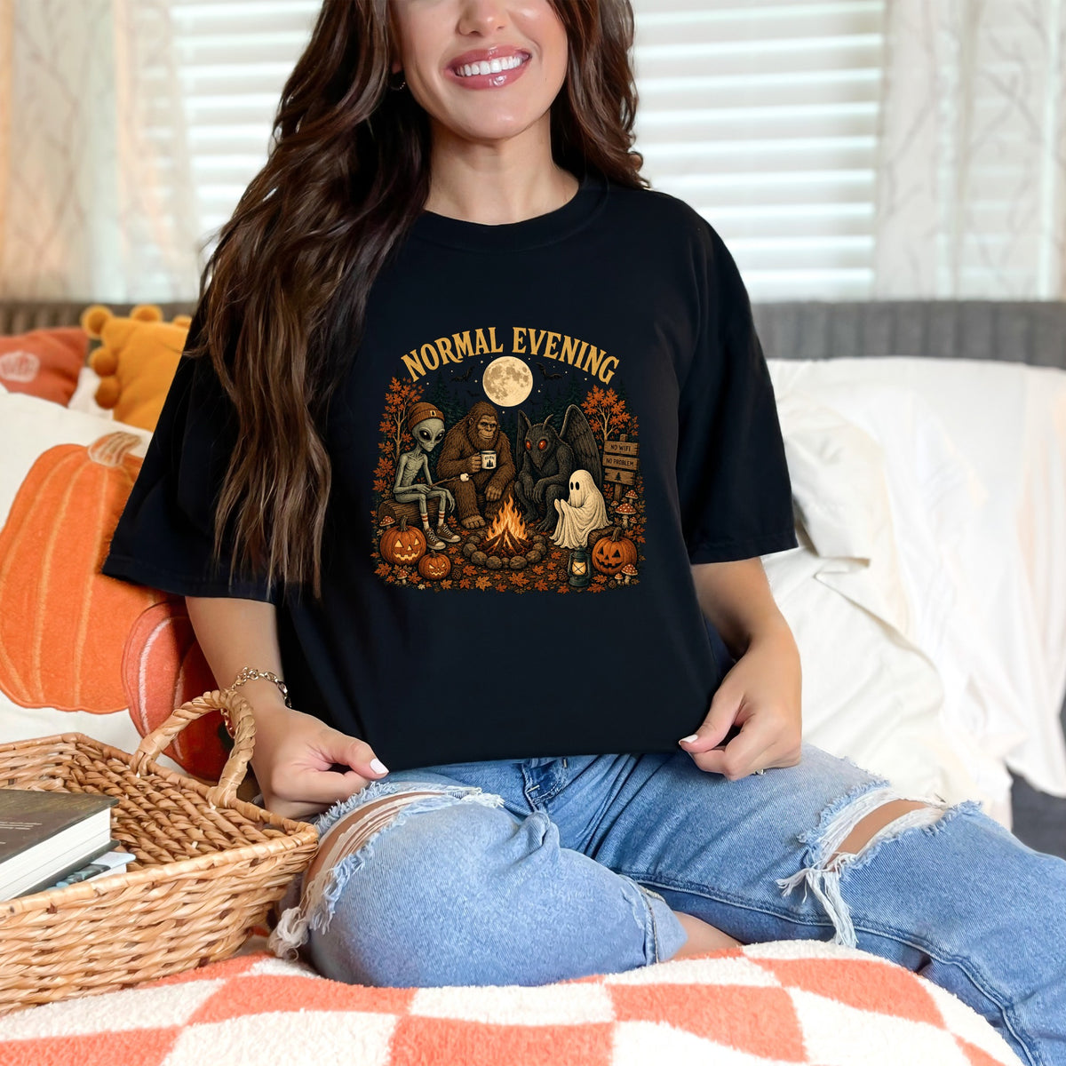 Black t-shirt with "Normal Evening" graphic of cryptids around a campfire.