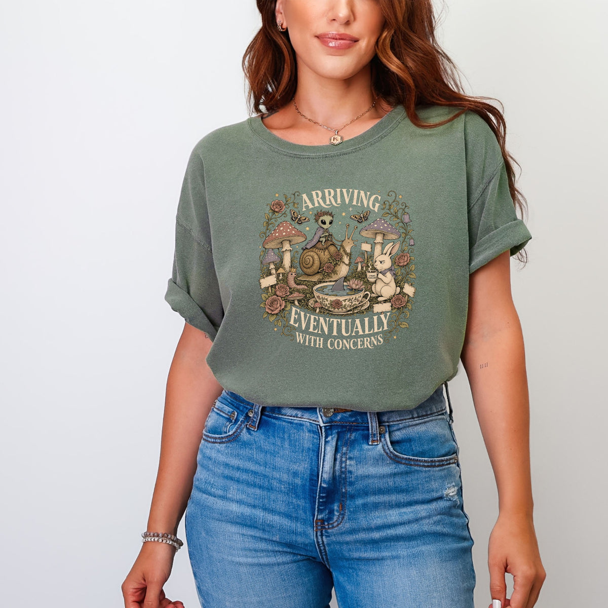 T-shirt with an alien riding a snail and text "ARRIVING EVENTUALLY WITH CONCERNS".