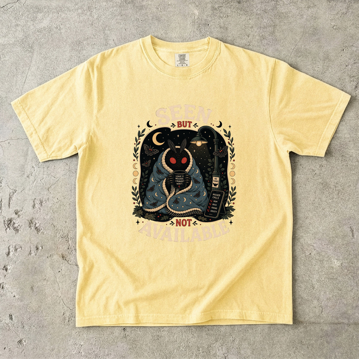 Yellow t-shirt with a moth graphic saying "SEEN BUT NOT AVAILABLE".