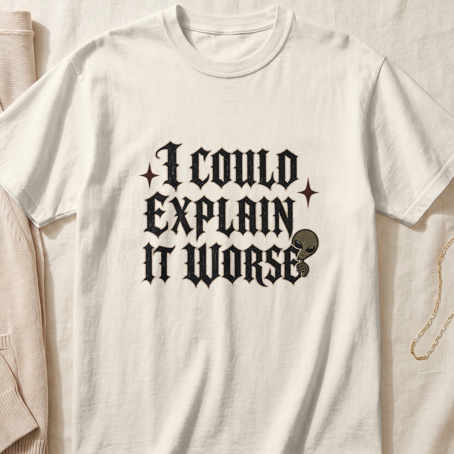 Cream t-shirt with "I COULD EXPLAIN IT WORSE" text and an alien graphic.