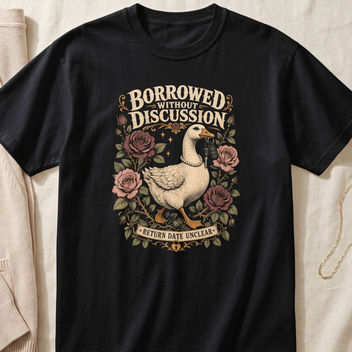 Black t-shirt with goose graphic, text "BORROWED WITHOUT DISCUSSION" and "RETURN DATE UNCLEAR".