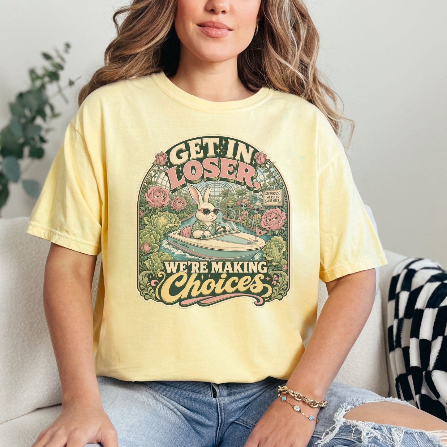 Graphic tee with rabbit driving boat, "GET IN LOSER WE'RE MAKING CHOICES" text.