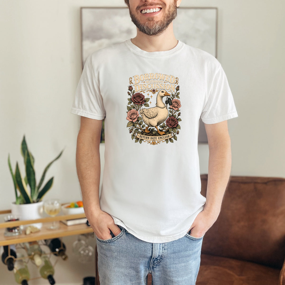 White t-shirt with goose graphic reading "BORROWED WITHOUT DISCUSSION" and "RETURN DATE UNCLEAR".