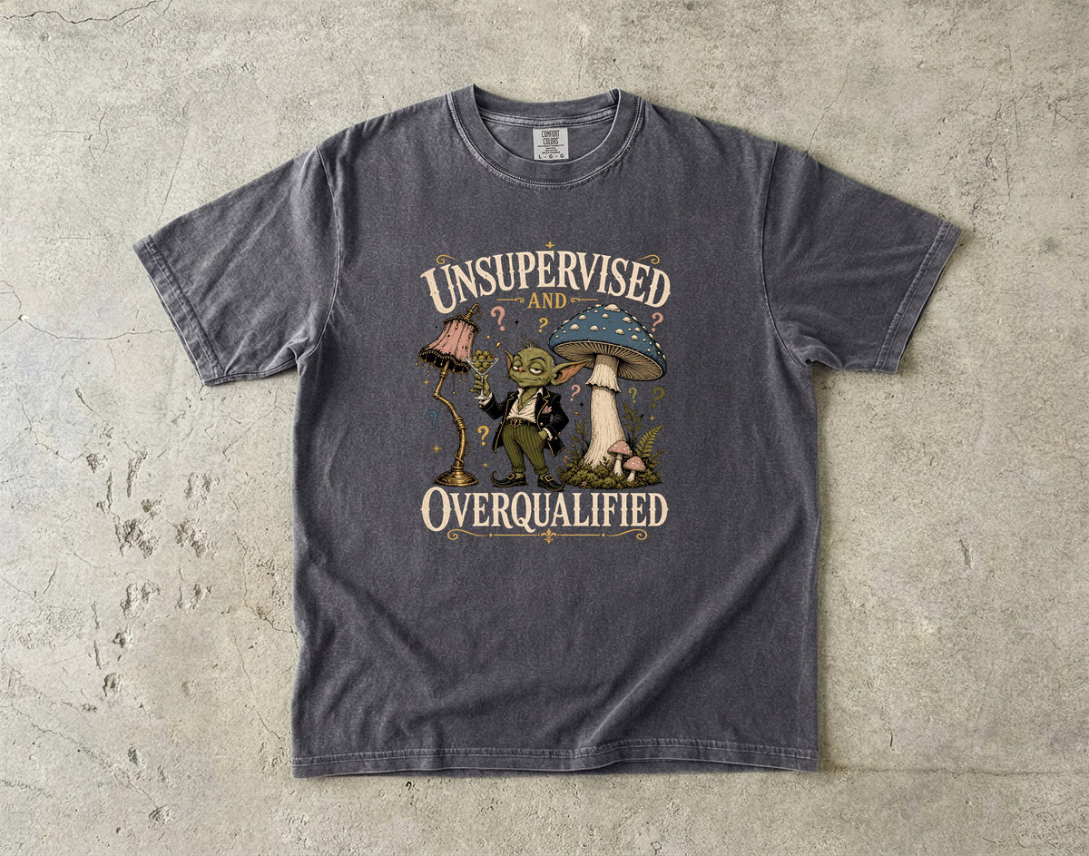 T-shirt with "UNSUPERVISED AND OVERQUALIFIED" text and a goblin character.