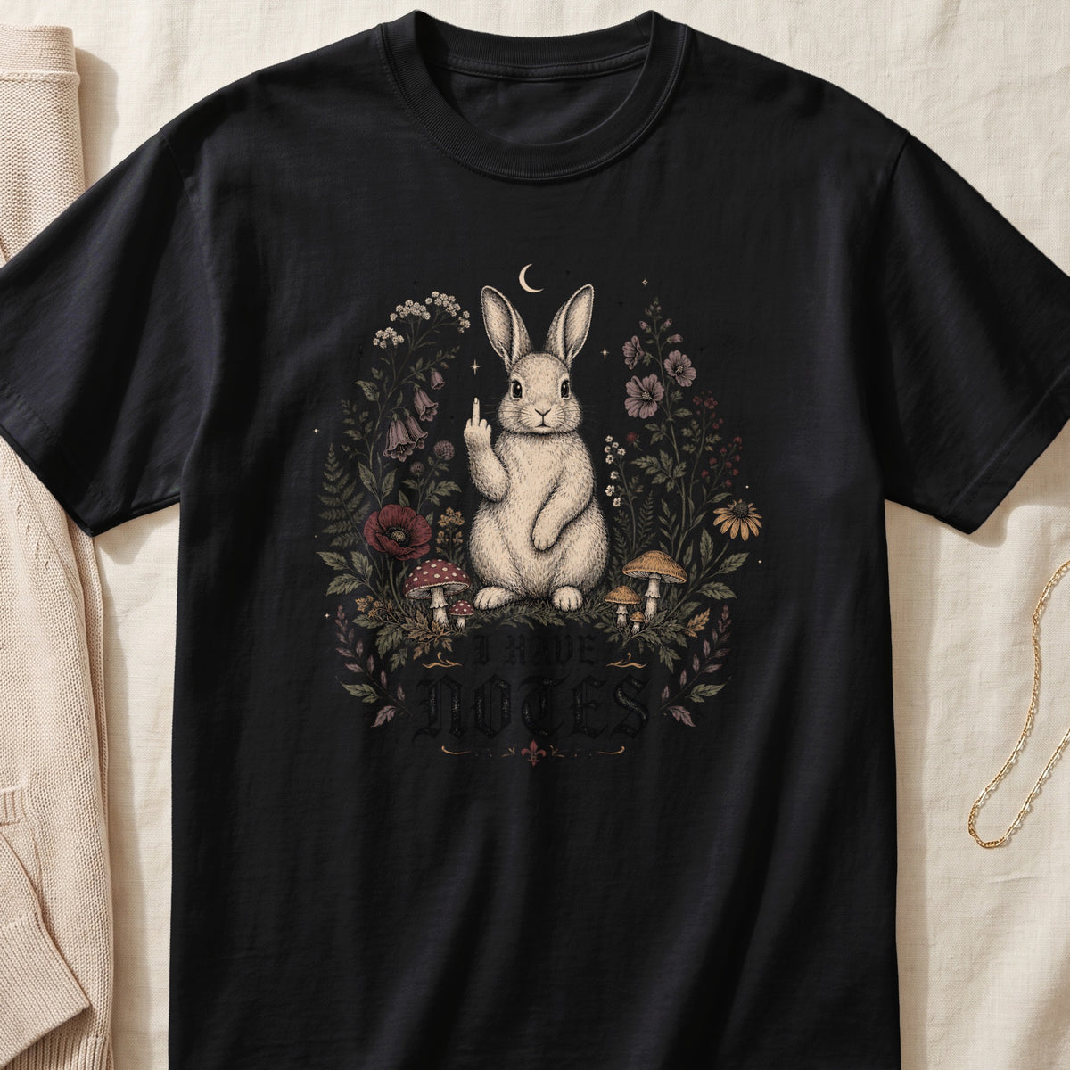 Black t-shirt with a rabbit giving the middle finger surrounded by flowers and mushrooms.