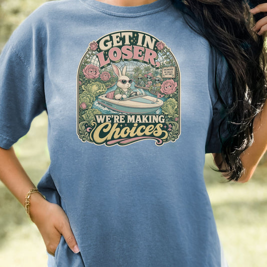 T-shirt graphic with text "Get in loser, we're making choices" and a bunny driving a boat.