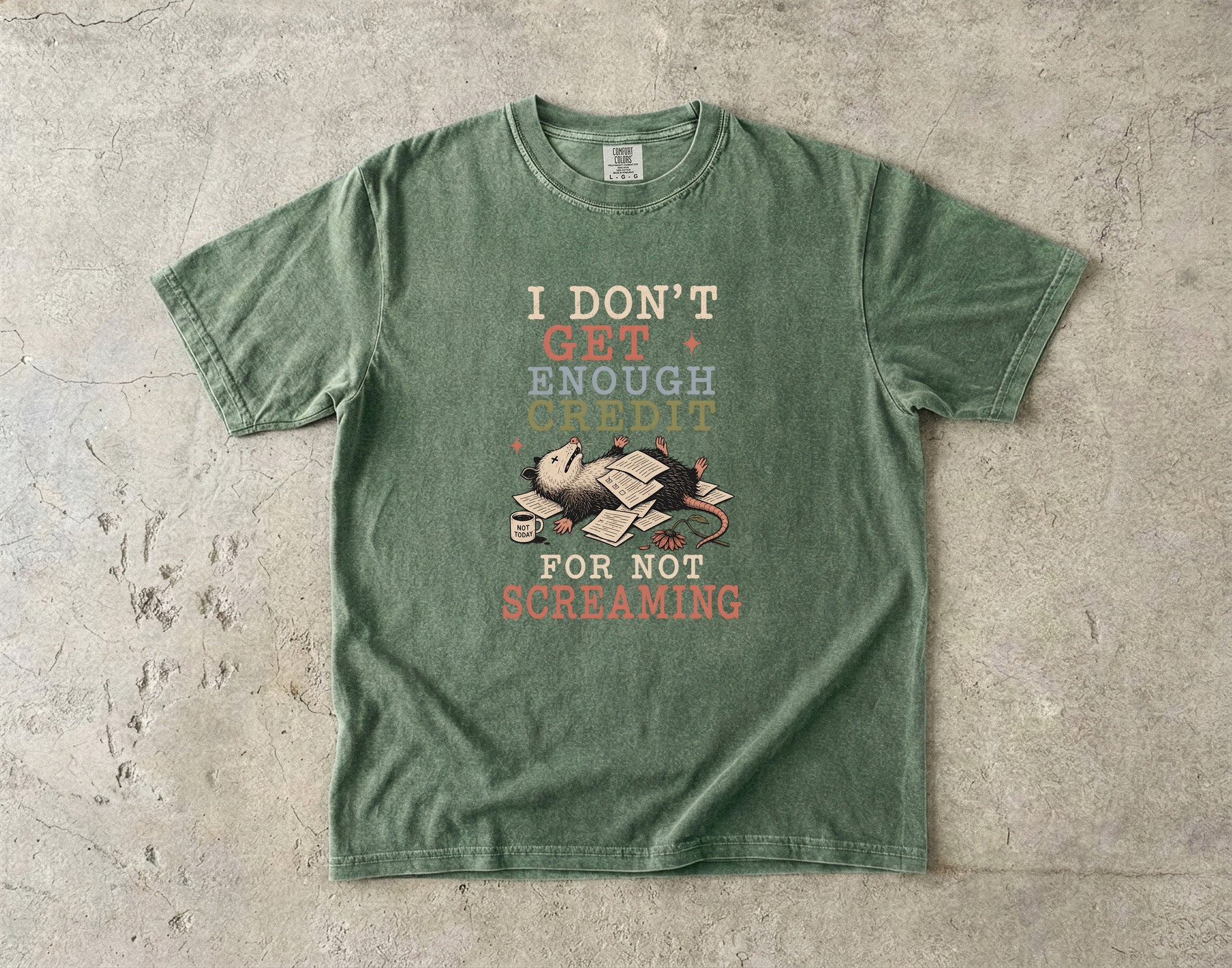 Green t-shirt with opossum and text "I DON'T GET ENOUGH CREDIT FOR NOT SCREAMING".