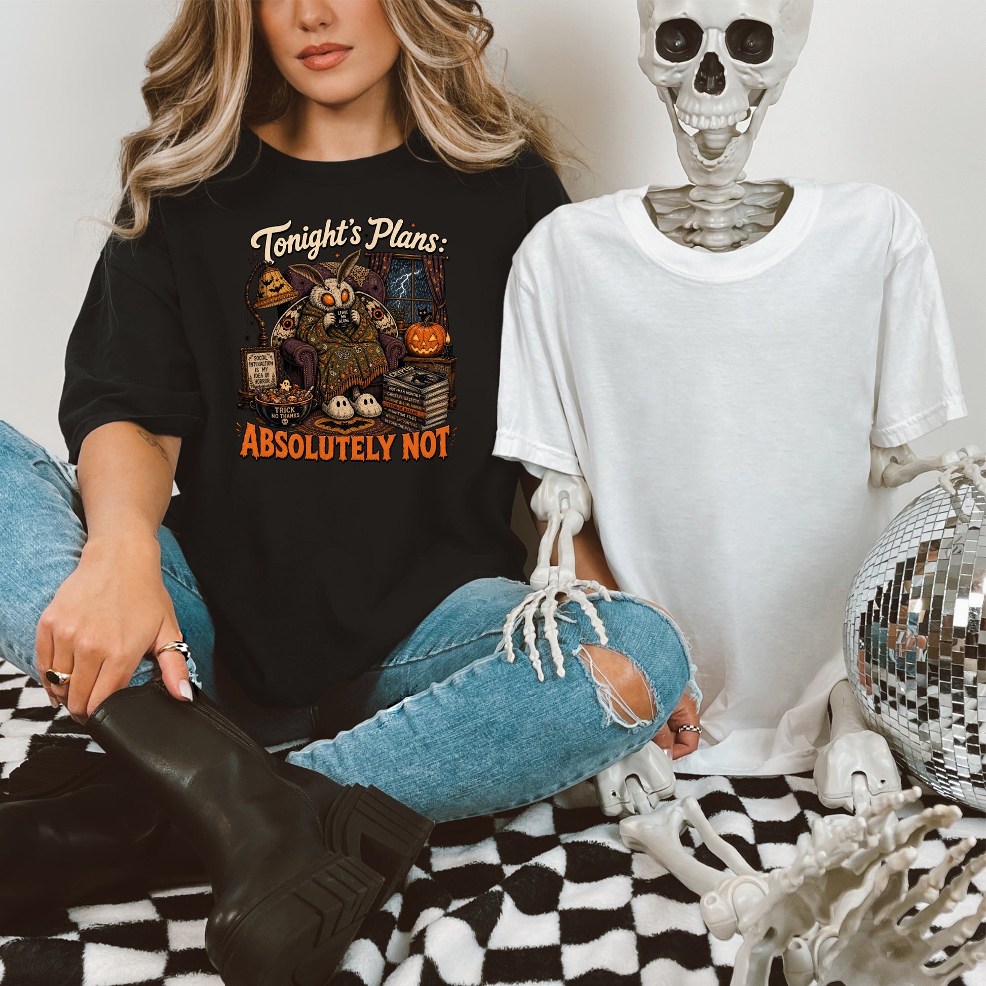 Black t-shirt graphic with mothman, books, and "Absolutely Not" text.