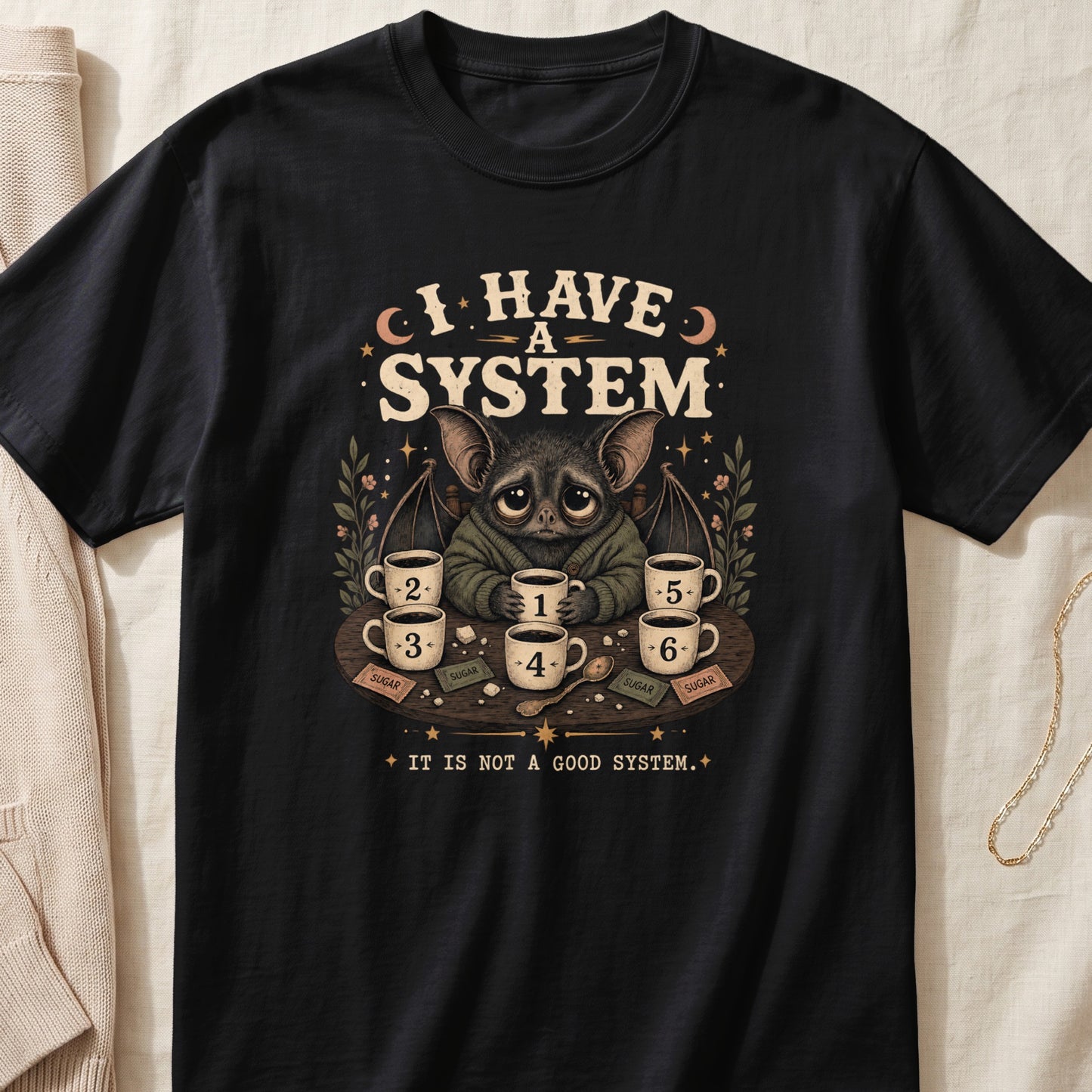 Bat with seven coffees on table, text "I HAVE A SYSTEM" and "IT IS NOT A GOOD SYSTEM".