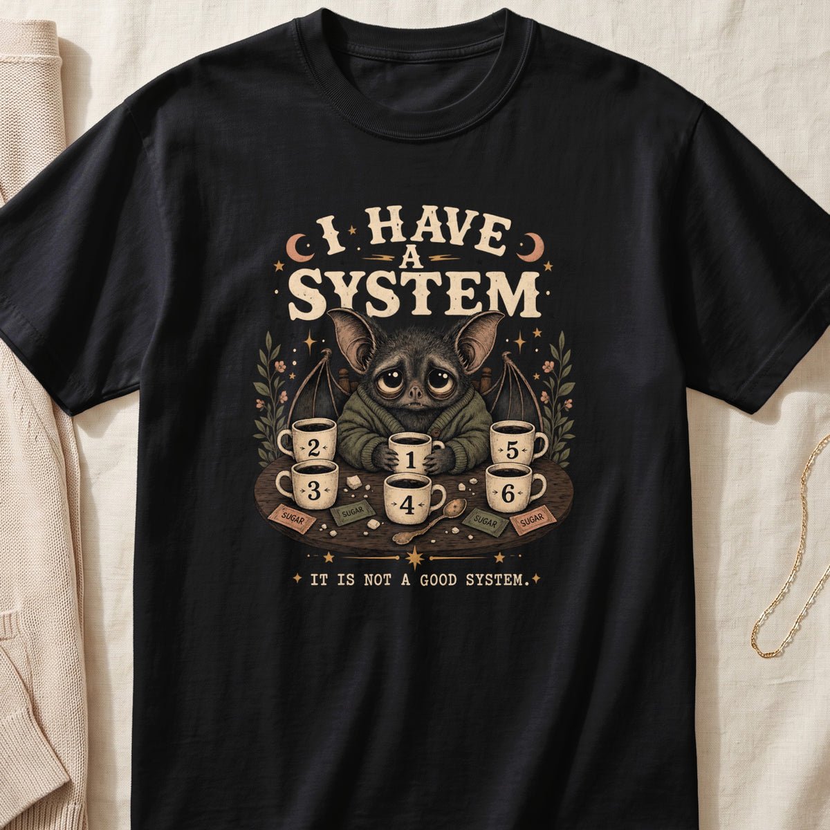 Bat with seven coffees on table, text "I HAVE A SYSTEM" and "IT IS NOT A GOOD SYSTEM".