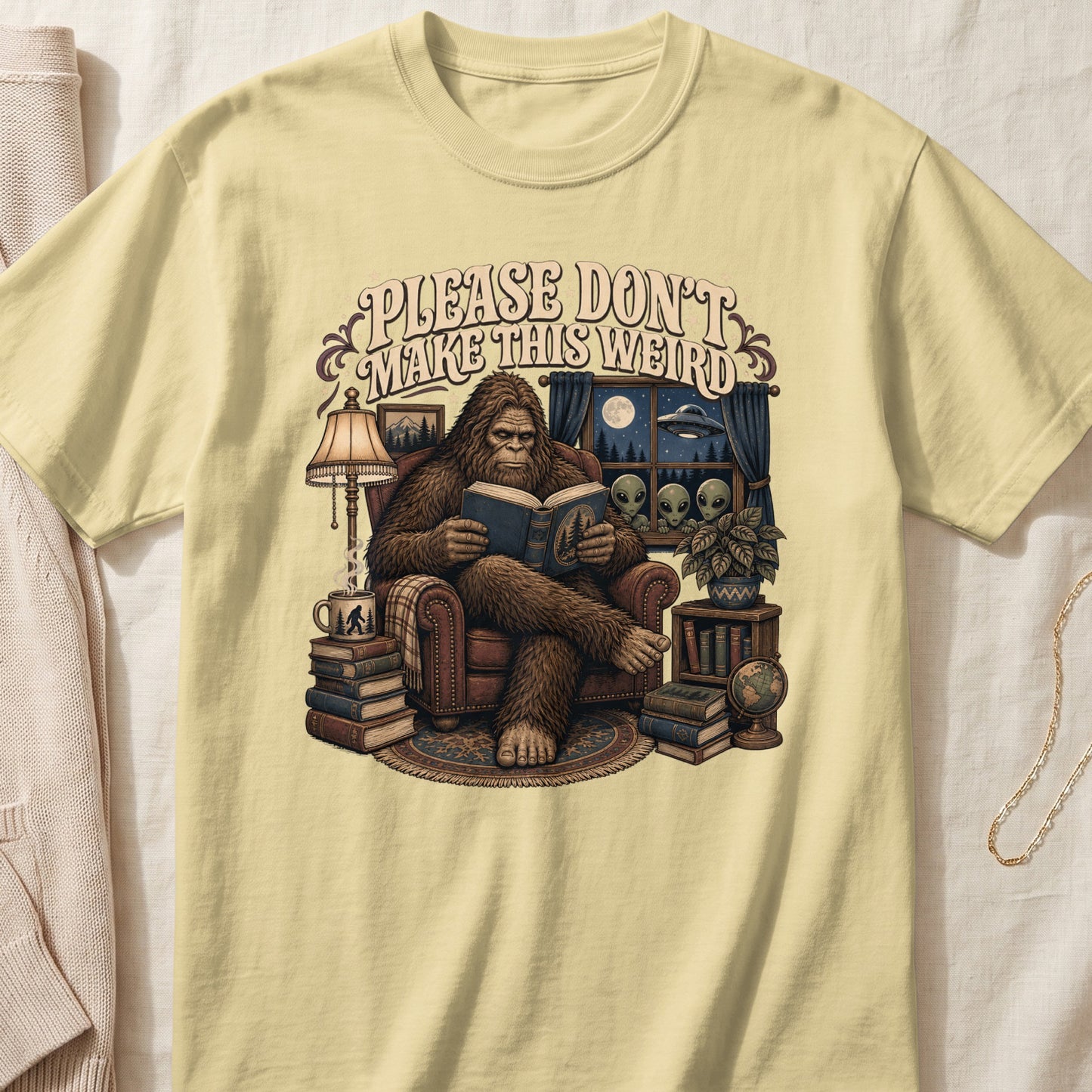 Bigfoot reading a book with aliens and UFO visible through a window.