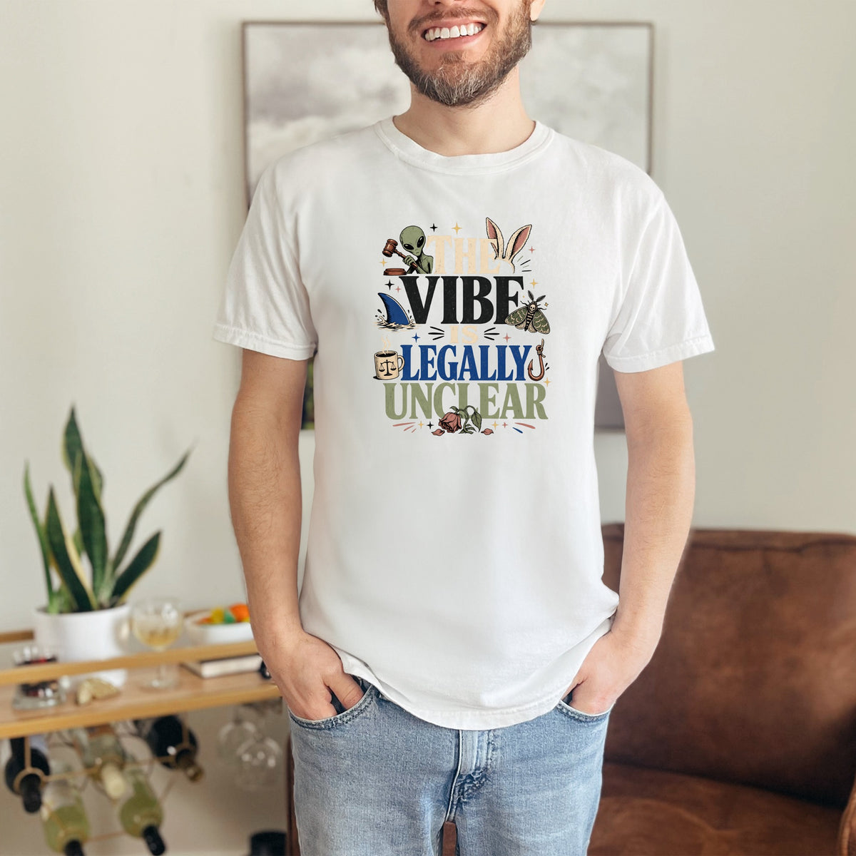 White t-shirt with "The Vibe is Legally Unclear" text and graphic elements.