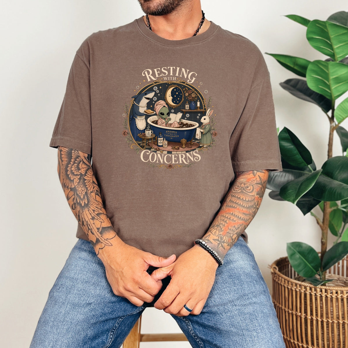 Brown t-shirt with graphic: alien, shark, rabbit relaxing in bath.