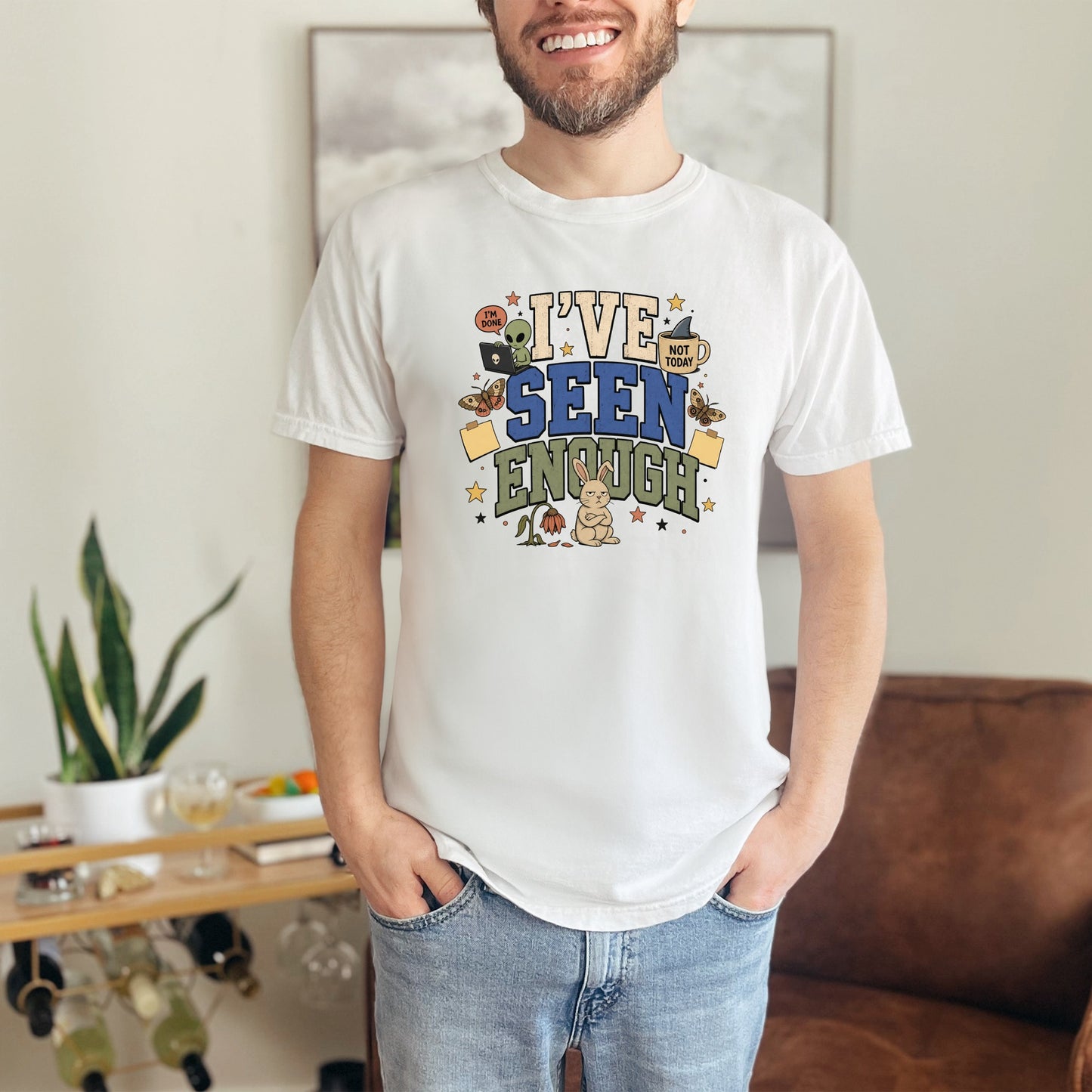 White t-shirt with "I'VE SEEN ENOUGH" text and cartoon graphics.