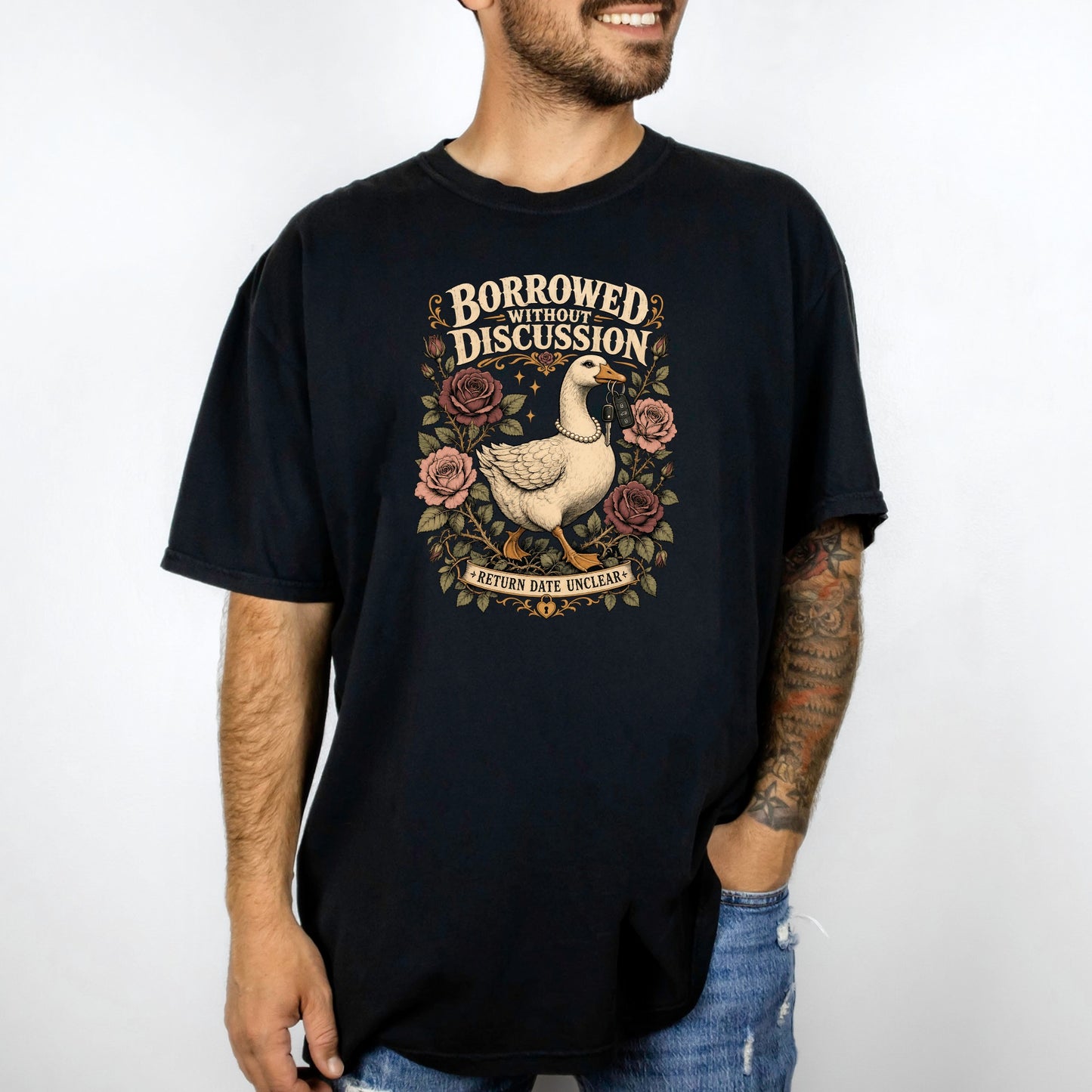 Black t-shirt with graphic of a goose holding keys, surrounded by roses and text.