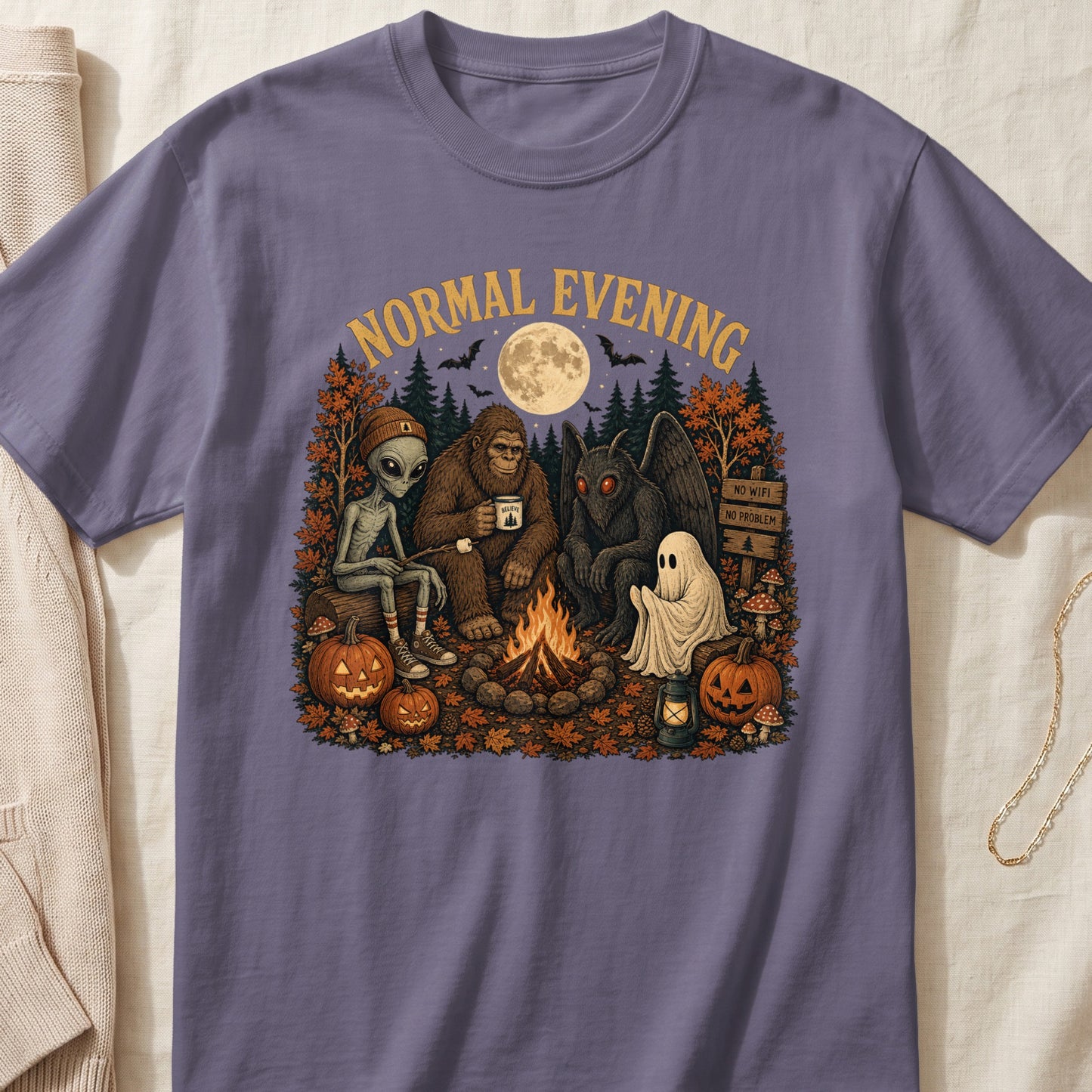 Illustration of Bigfoot, alien, Mothman, and ghost by campfire with pumpkins and text.