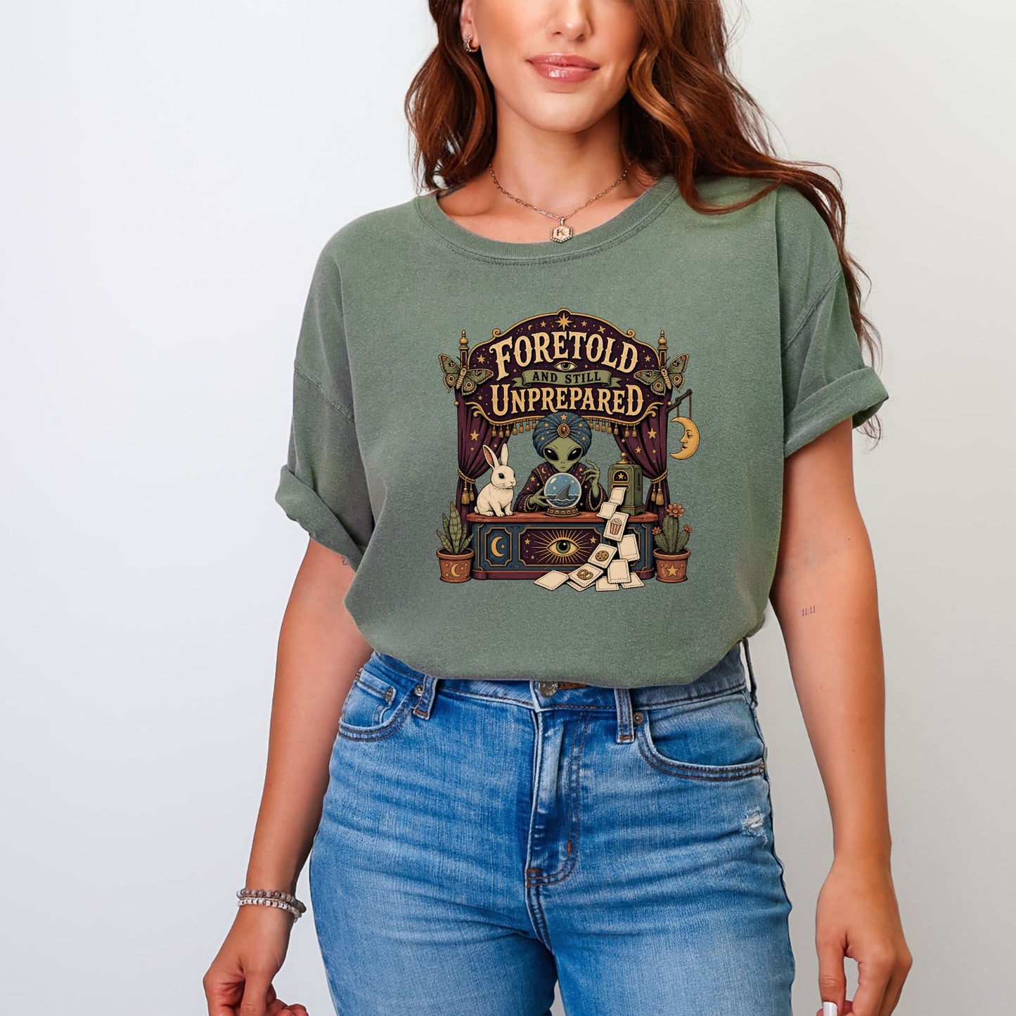 Graphic tee with an alien fortuneteller, rabbit, and "Foretold and Still Unprepared" text.