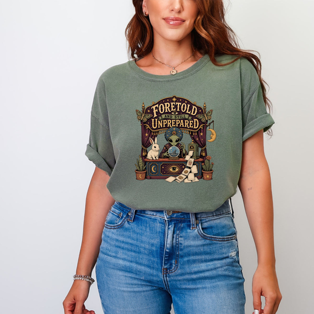Graphic tee with an alien fortuneteller, rabbit, and "Foretold and Still Unprepared" text.