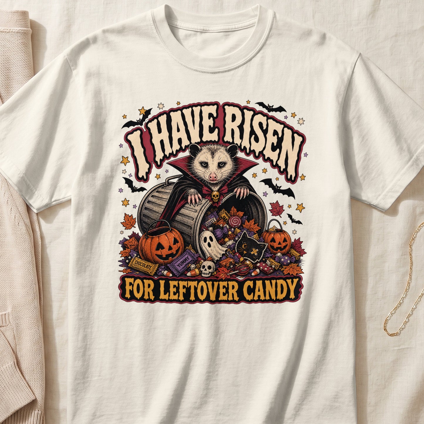 Halloween possum in vampire costume with candy and pumpkins, text "I HAVE RISEN FOR LEFTOVER CANDY".