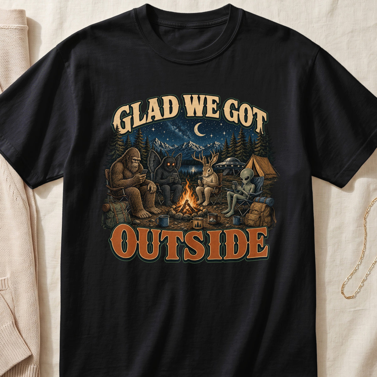 Bigfoot, mothman, deer, and alien camping under the stars.