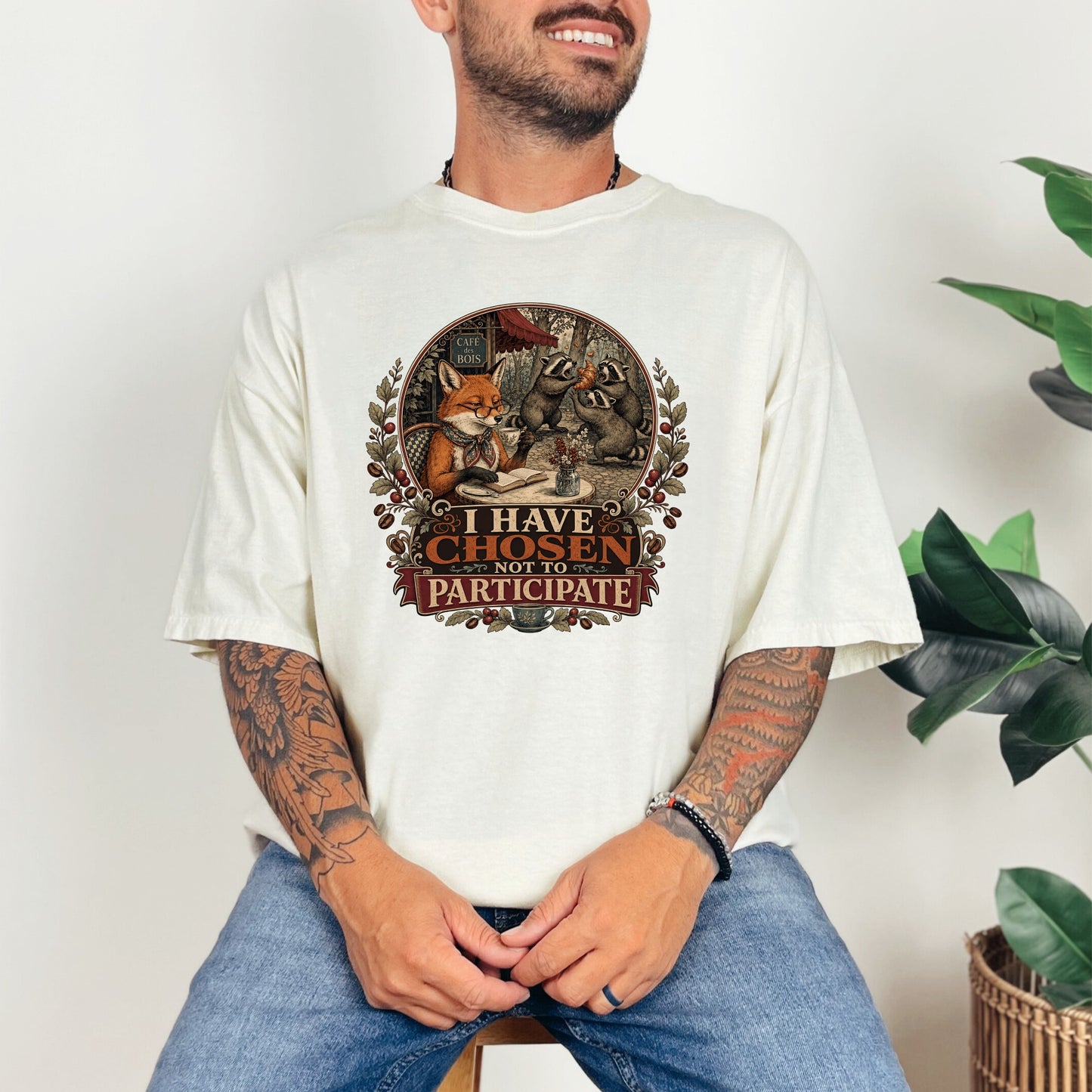 T-shirt with graphic of foxes and raccoons at a cafe reading and eating, saying "I Have Chosen Not To Participate."
