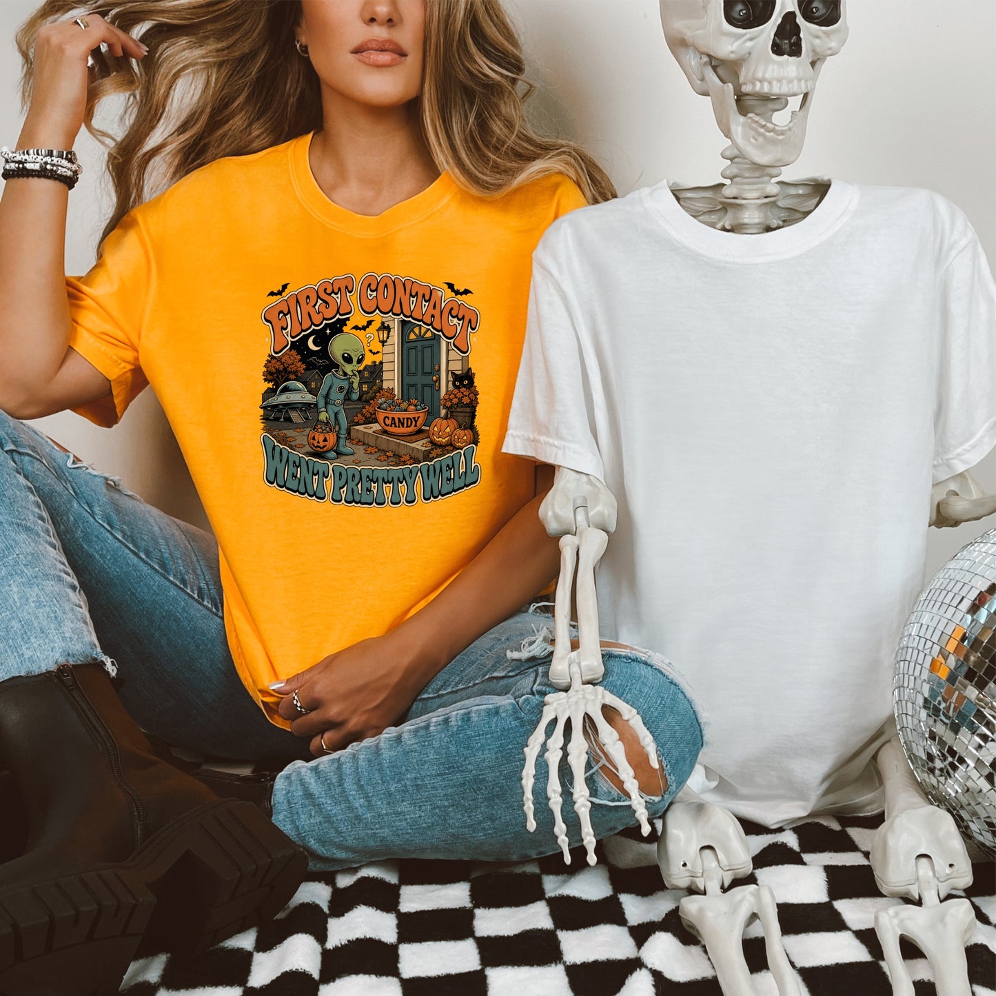 Orange t-shirt with "First Contact Went Pretty Well" and alien Halloween graphic.