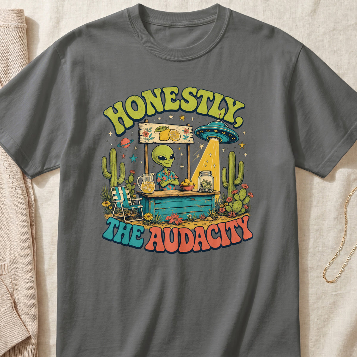 Retro graphic with alien at lemonade stand, UFO, and text "HONESTLY, THE AUDACITY".