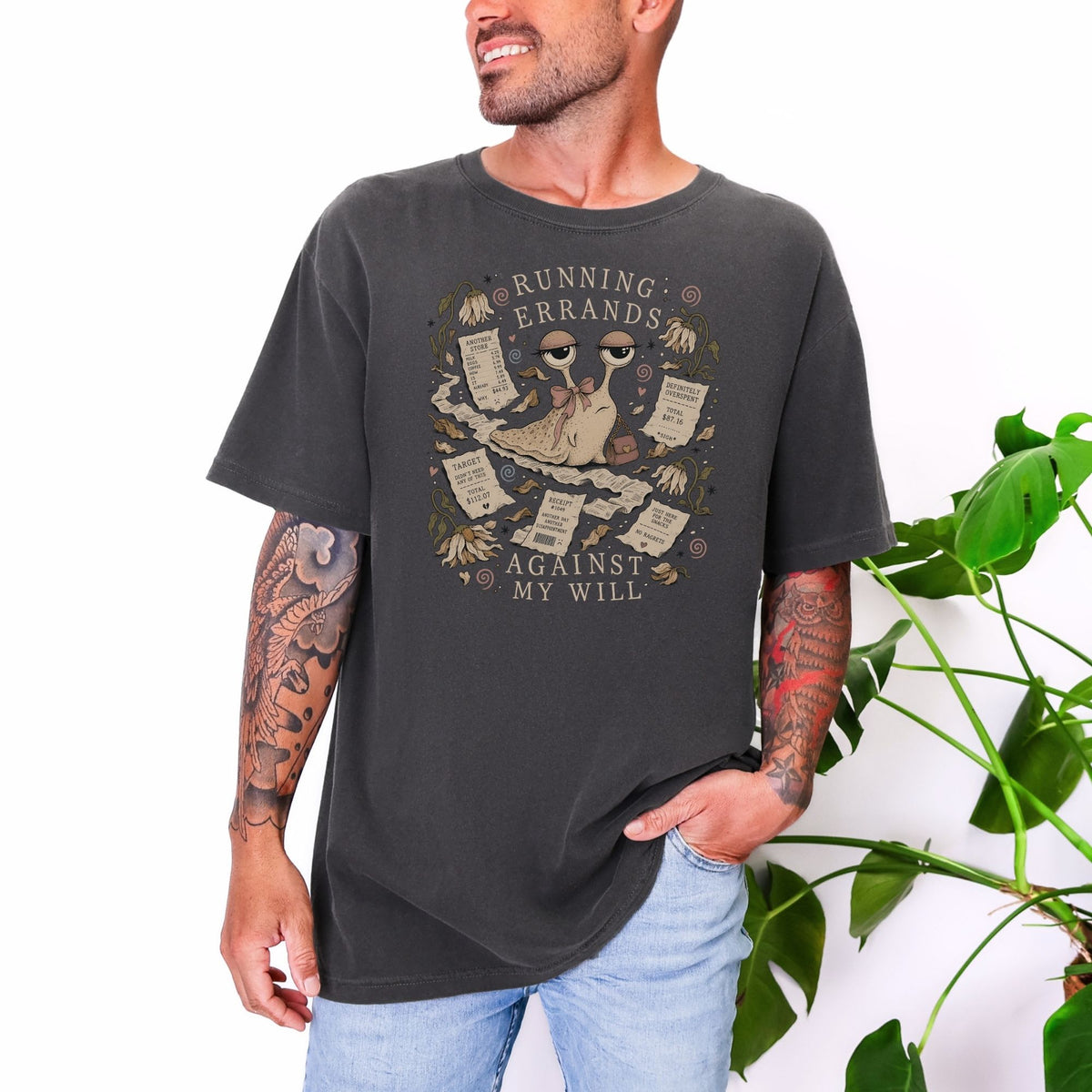 Dark grey t-shirt with snail illustration and text "RUNNING ERRANDS AGAINST MY WILL".