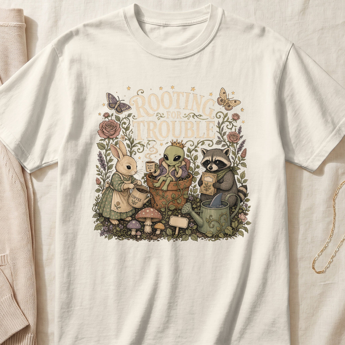 Rabbit, alien, and raccoon gardening with text "ROOTING FOR TROUBLE".
