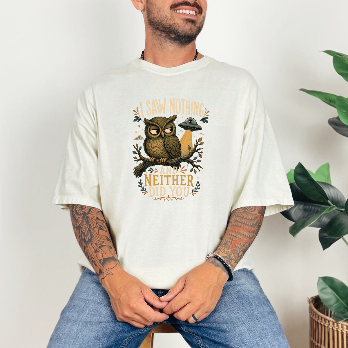 T-shirt graphic with owl, UFO, and text "I saw nothing and neither did you."