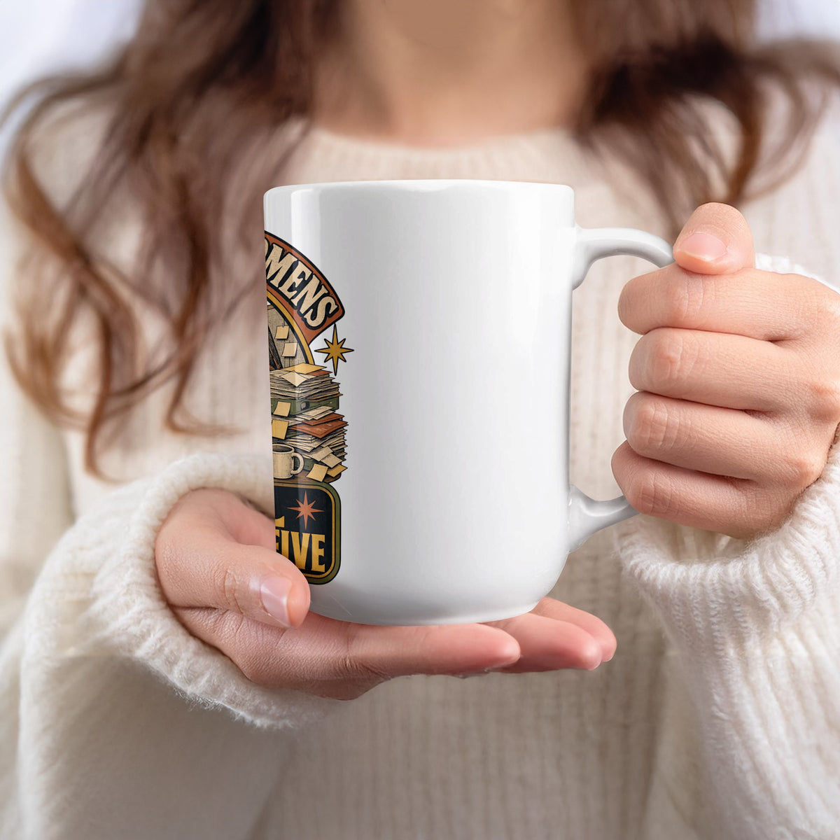 White mug with a graphic of books, a starburst, and text "MENS" and "FIVE".