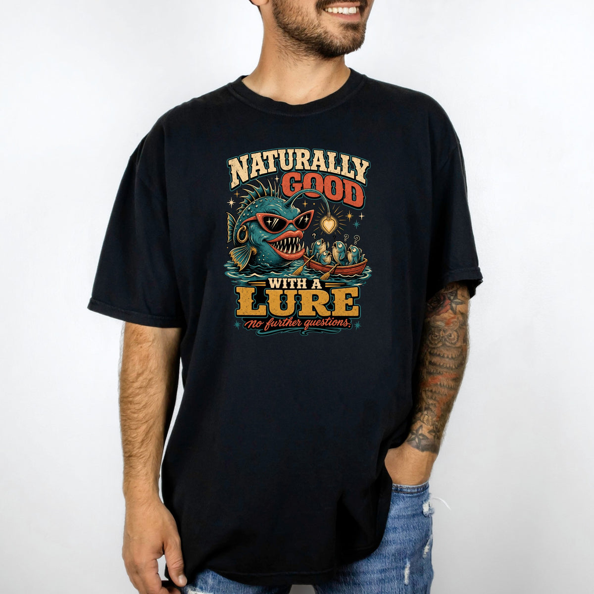 T-shirt graphic with anglerfish in sunglasses and text "Naturally Good With A Lure".