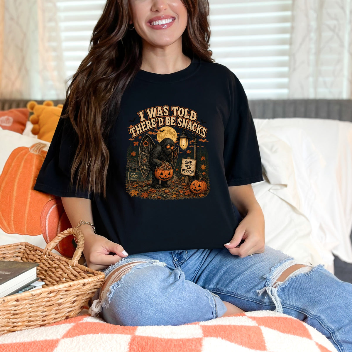 Black t-shirt with Mothman graphic and text "I WAS TOLD THERE'D BE SNACKS".