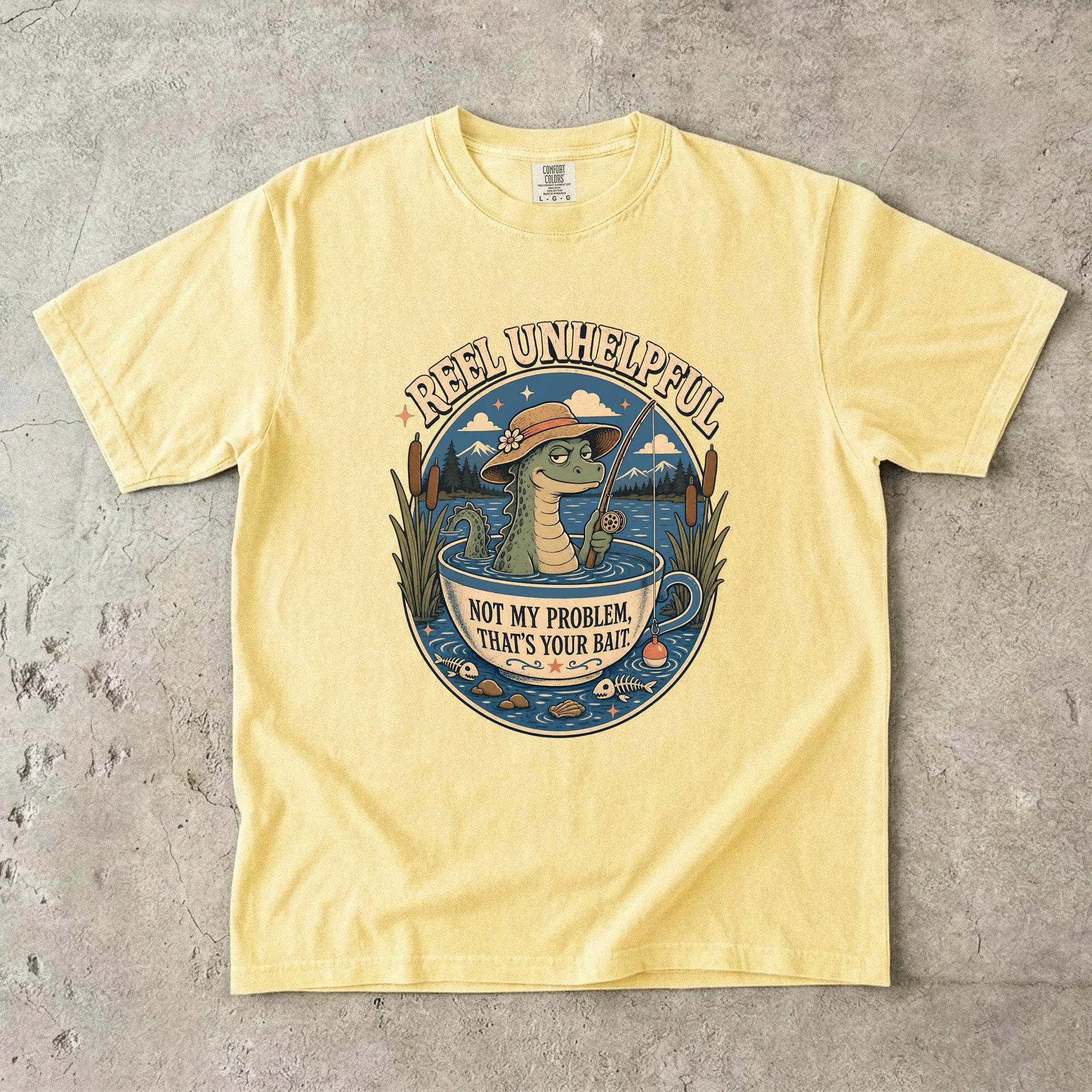 Yellow t-shirt with "Reel Unhelpful" and alligator fishing in a teacup graphic.