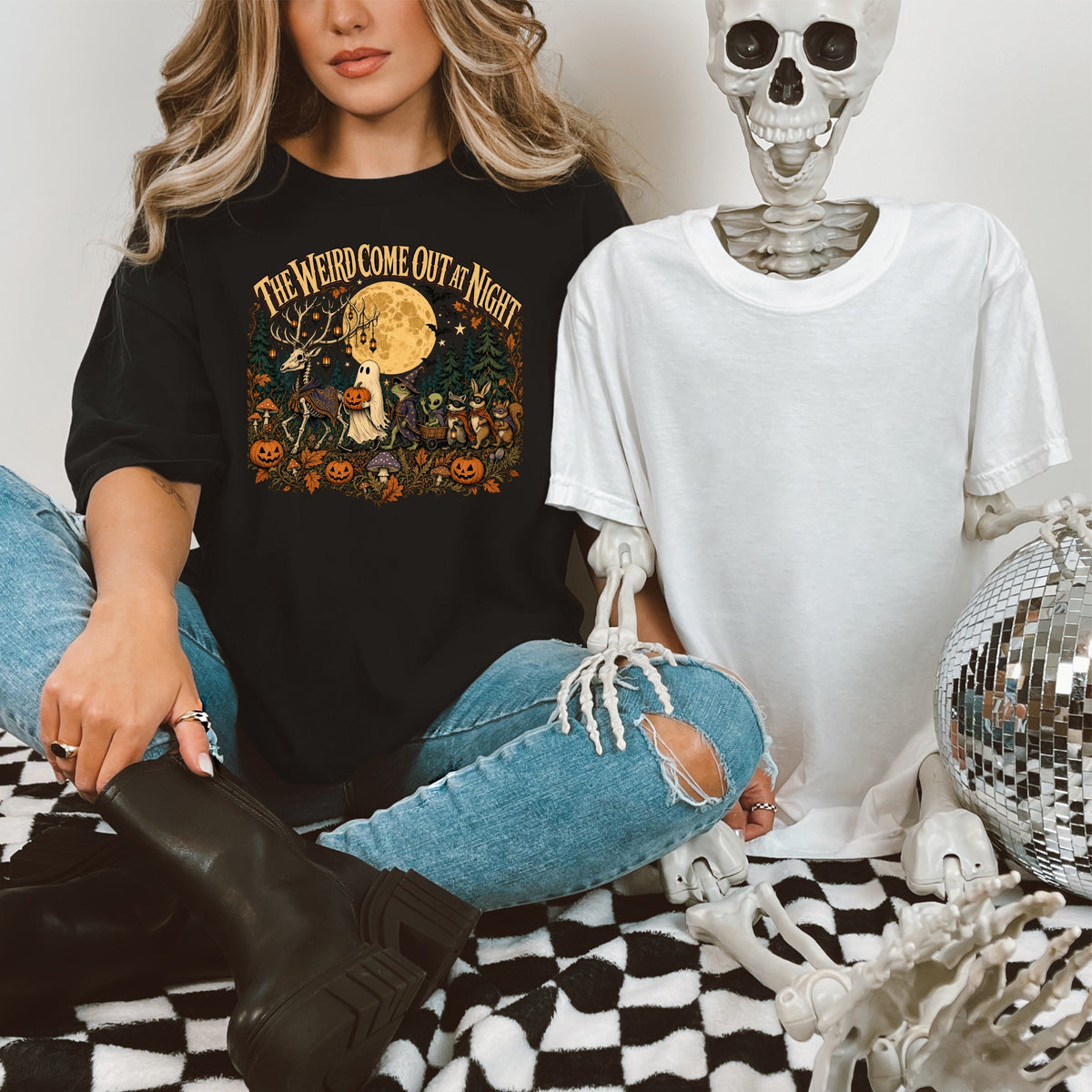 Black t-shirt with "The Weird Come Out At Night" text and Halloween graphic.