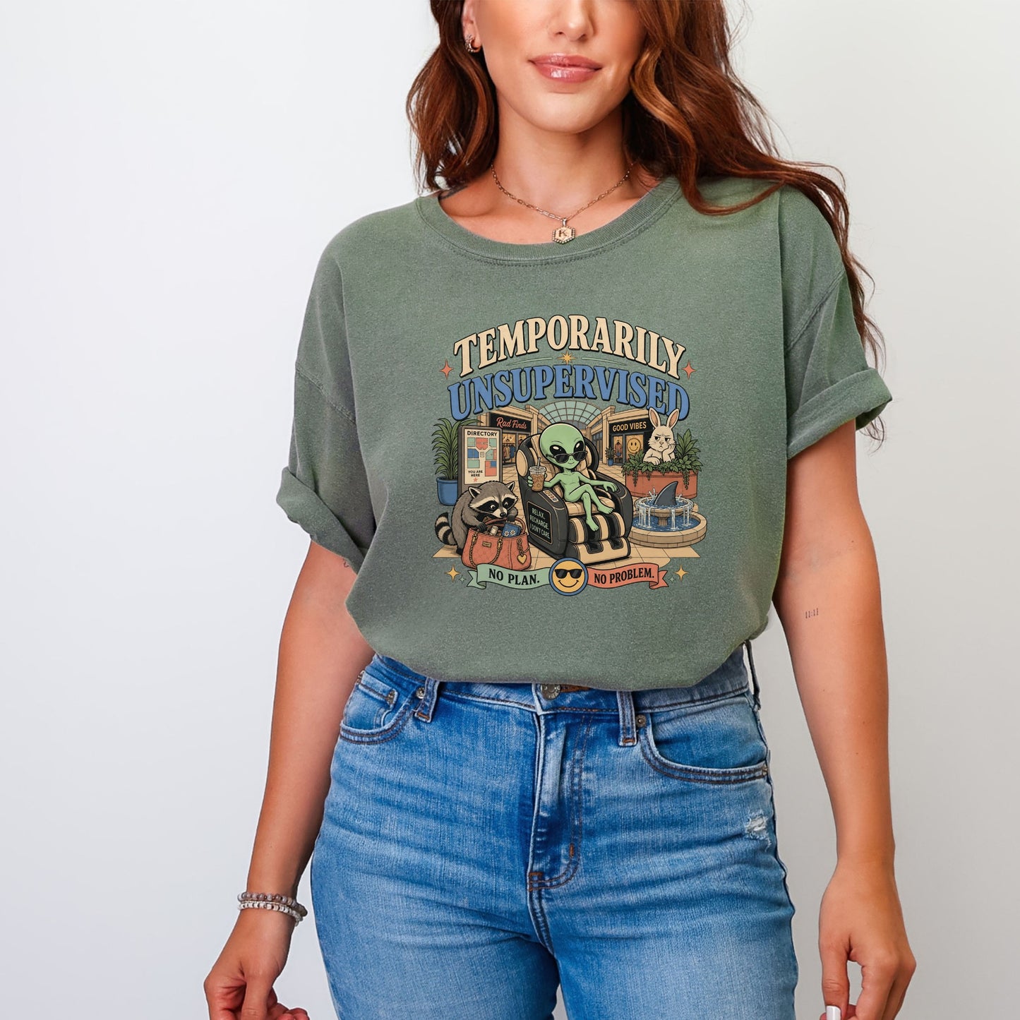 Green t-shirt with retro graphic: "Temporarily Unsupervised" text, alien, raccoon, and bunny.