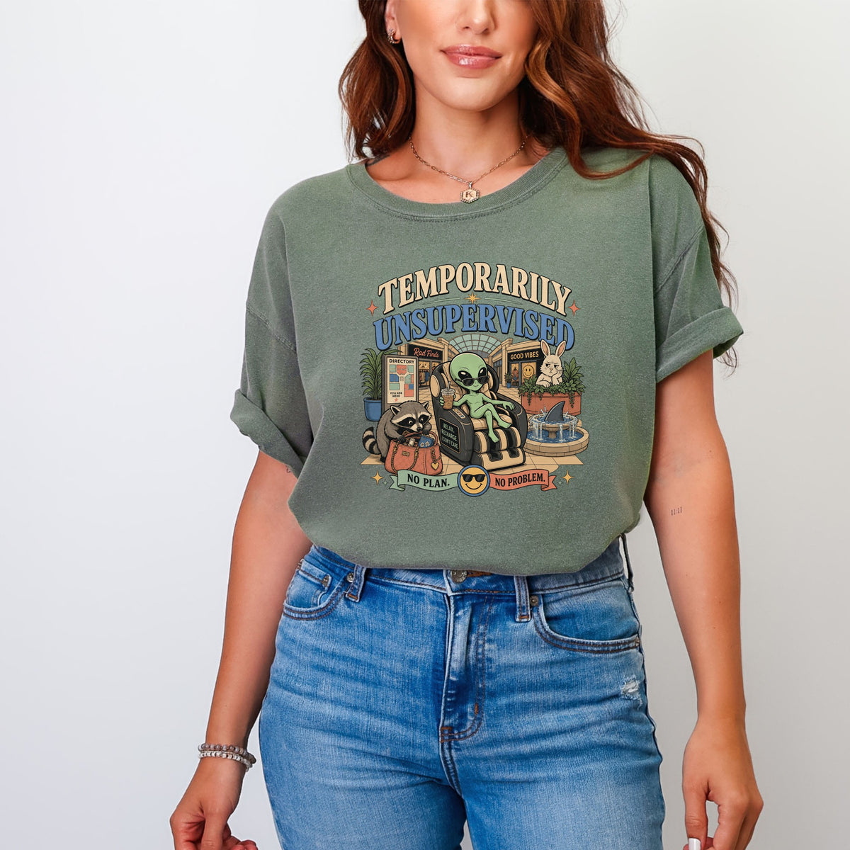 Green t-shirt with retro graphic: "Temporarily Unsupervised" text, alien, raccoon, and bunny.