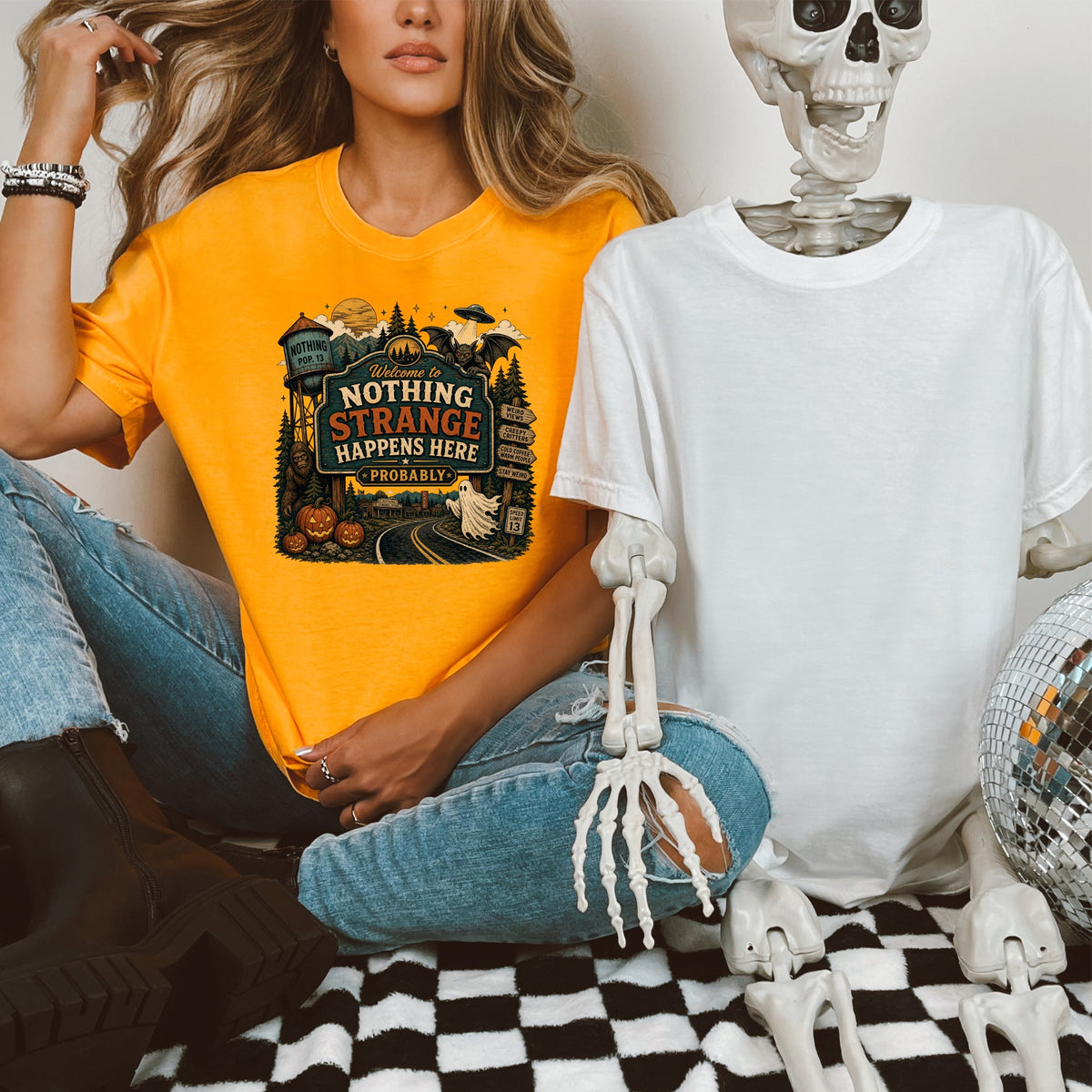 Orange t-shirt with "Welcome to Nothing Strange Happens Here Probably" graphic.