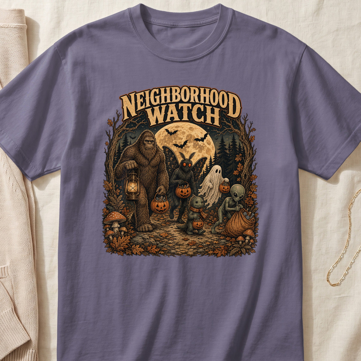 Neighborhood Watch t-shirt with Bigfoot, mothman, ghost, dinosaur, and alien trick-or-treating.