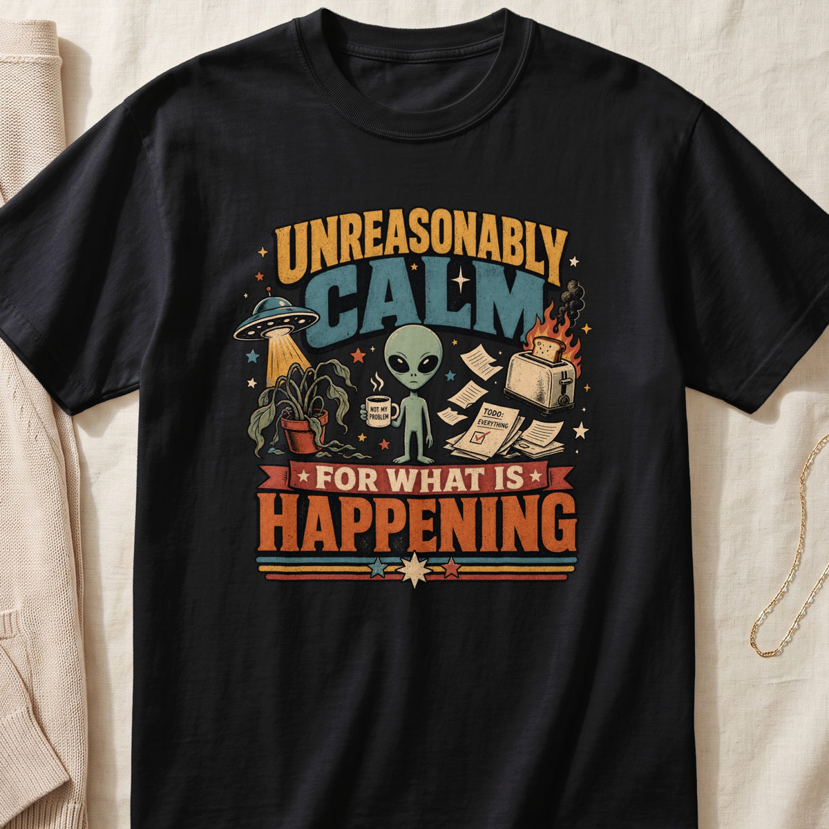 Black t-shirt featuring a retro graphic of a calm alien, a UFO, and a burning toaster with text.