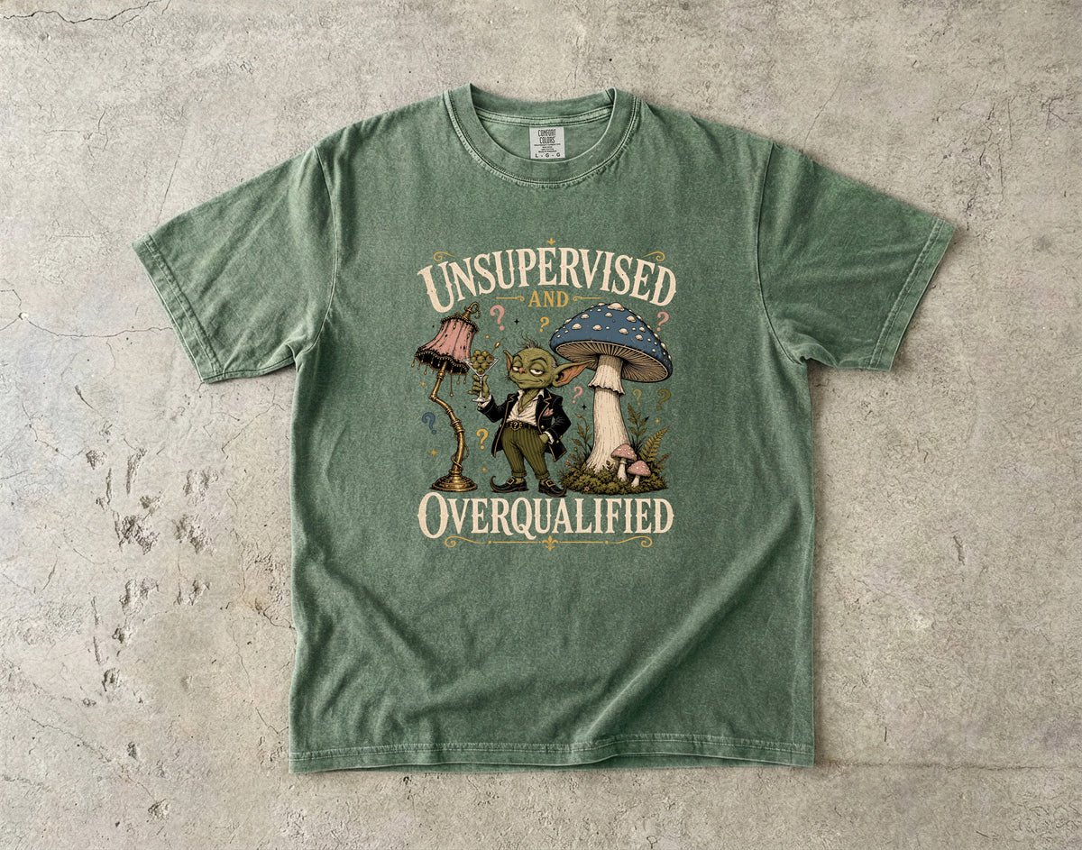 Green t-shirt with graphic art and text "UNSUPERVISED AND OVERQUALIFIED".