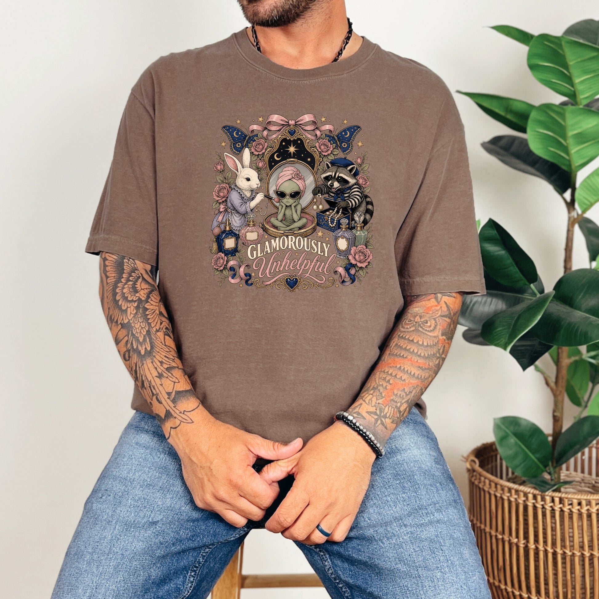 T-shirt with alien, rabbit, and raccoon amidst flowers and text "GLAMOROUSLY Unhelpful".